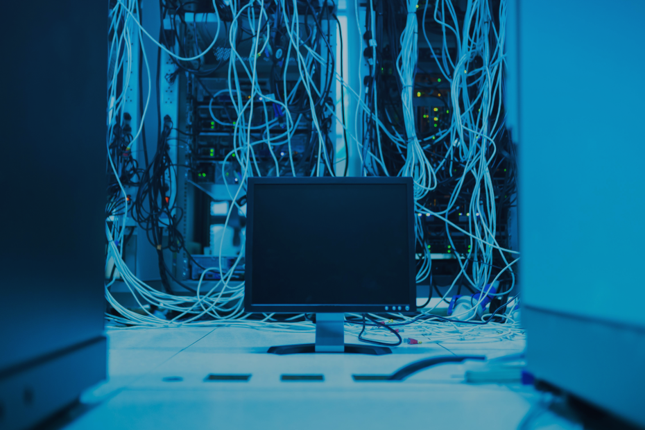 Blue-lit server room with tangled network cables