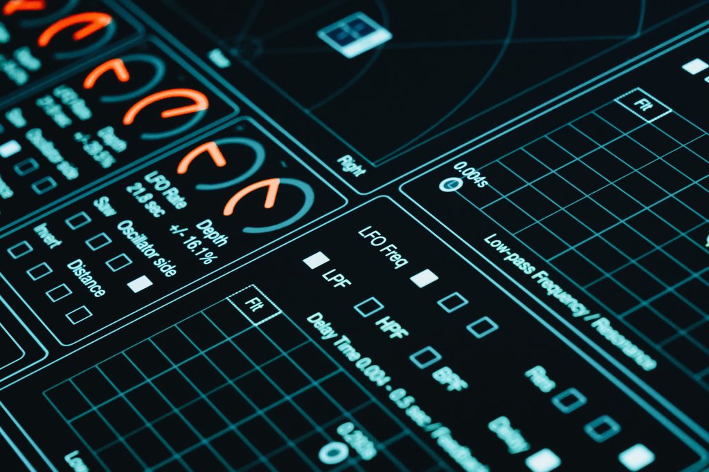Close-up of a digital interface showcasing futuristic graphs and business data analytics in low light.