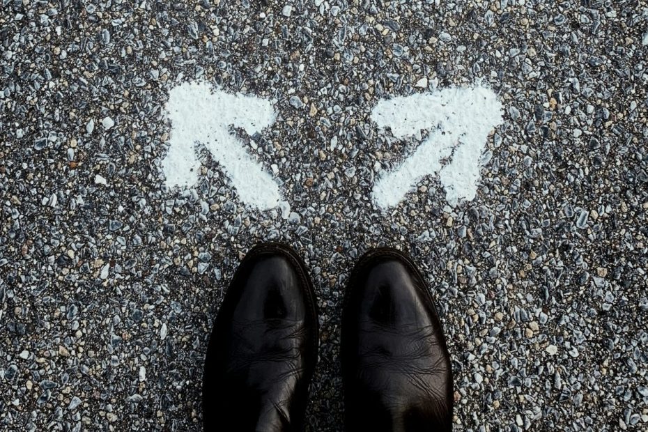 Looking down at two arrows pointing in opposite directions - deciding between Cyber Essentials and Cyber Essentials Plus certification depends on your organisation's specific requirements
